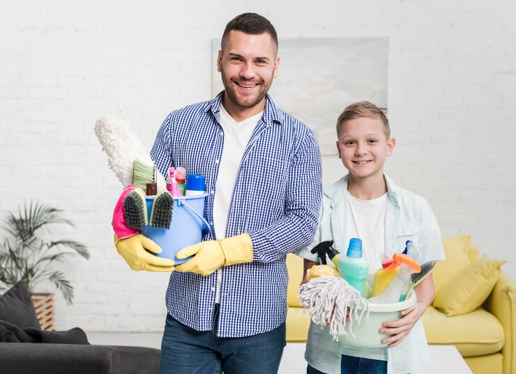 smiley-father-son-posing-with-cleaning-products_23-2148456994